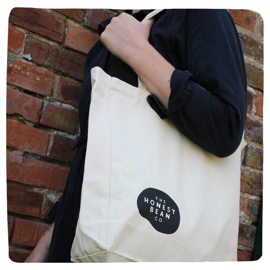 The honest bean tote bag being worn over a shoulder